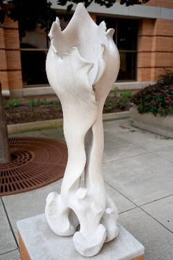 White sculpture of an oversized bone.